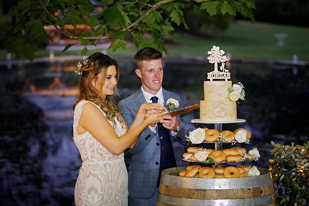 cutting the cake outdoor reception fernbank farm 