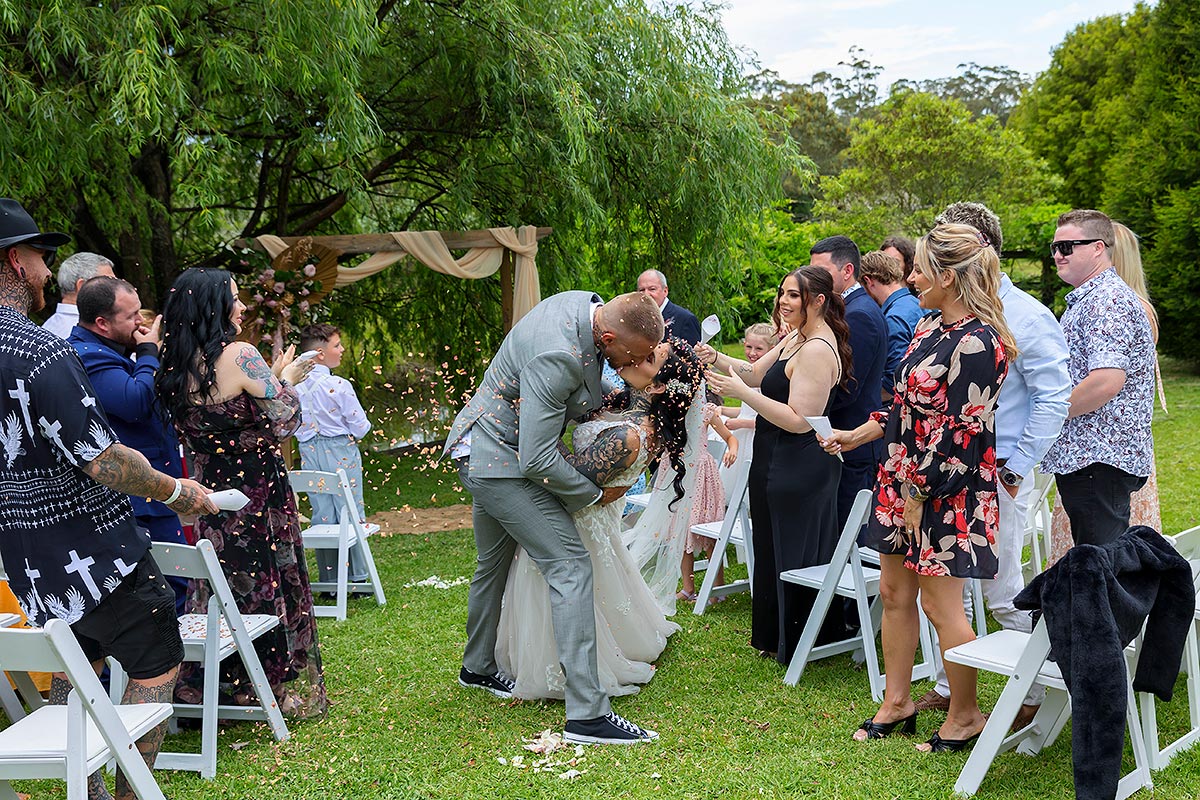 bride and groom kissing walking back up aisle 