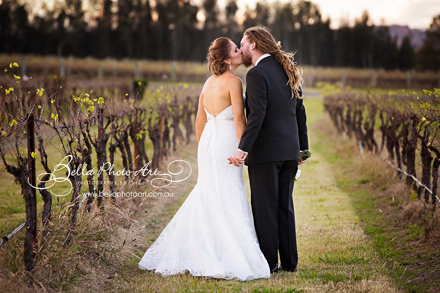 bride and groom in the vines at peterson house