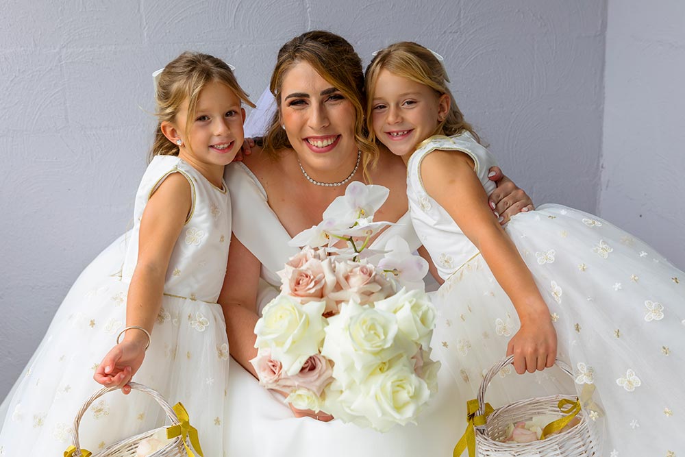 bride with flowers girls in white dresses
