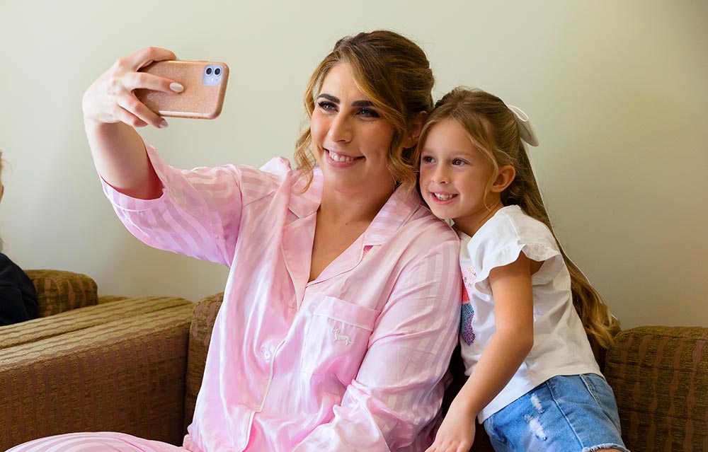 bride with flower girl before getting dressed