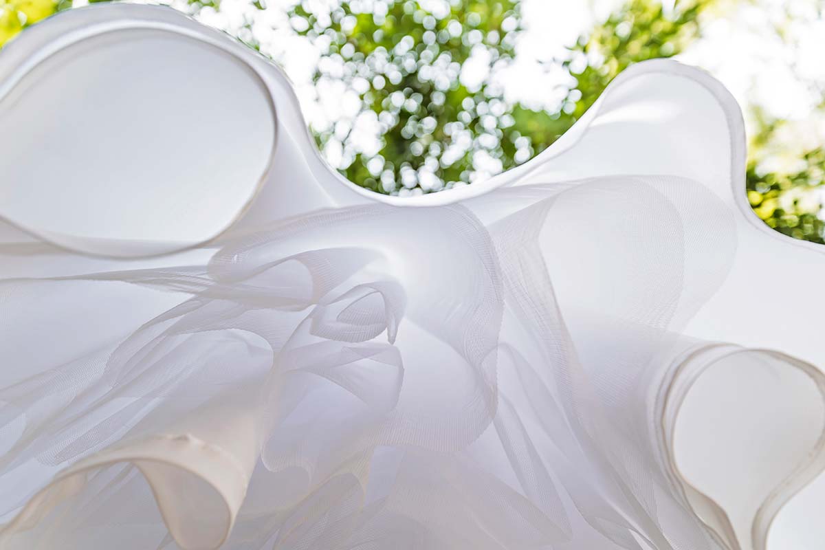 wedding dress details hanging from a tree